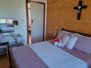 a bedroom with a bed with two pairs of shoes on it at Mai lo stesso in Kakamas
