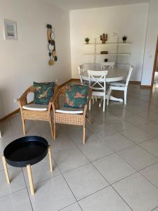 a living room with a table and chairs and a dining room at Jardins de Santa Eulália By Albufeira Rental in Albufeira