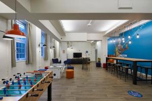 a room with blue walls and tables and chairs at Frances Gardner in London