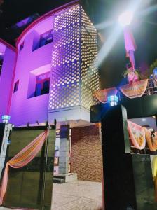 een gebouw met paarse lichten erop bij HOTEL KALPAVRIKSH PRAYAGRAJ in Prayagraj