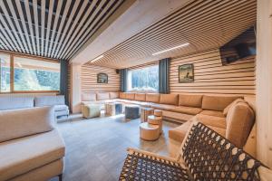 a living room with a couch and a table at L'Auberge Nordique in Le Grand-Bornand