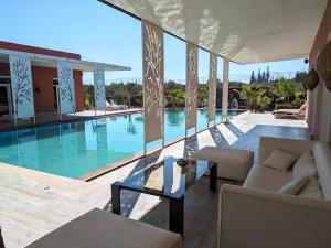 a view of a swimming pool from a house at Villas Green in Marrakech