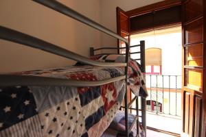 a bedroom with a bunk bed with an american flag blanket at Apartamento Corazón de Triana in Seville