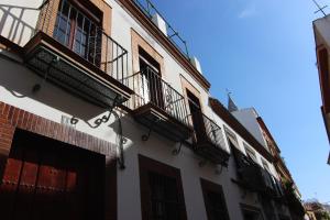 a building with balconies on the side of it at Apartamento Corazón de Triana in Seville