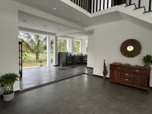 a large living room with a staircase and a table at Shades Hotel & Villa in Matara