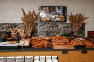 a bakery with bread and pastries on a counter at Wyndham Garden Burabay in Borovoye