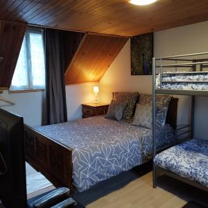 a bedroom with a bunk bed and a desk at Les Tilleuls in Le Bourg-dʼOisans