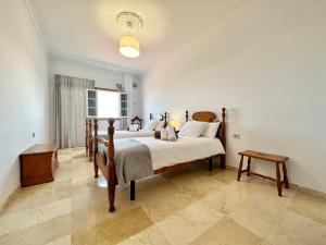 a bedroom with two beds with white sheets and a window at Villa Puntallana in Arafo +37 photos