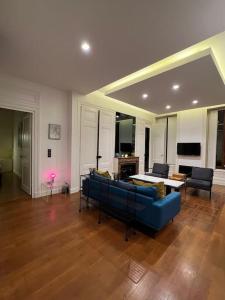 a living room with a blue couch and a table at Stunning apartment in the center of Lyon ! in Lyon