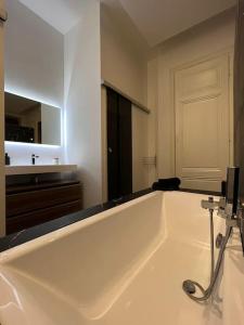a large white bath tub in a bathroom at Stunning apartment in the center of Lyon ! in Lyon