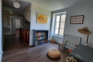 a living room with a book shelf with books at Cabana & La Jolie Ferme - Entre Chalon et Mâcon in Nanton