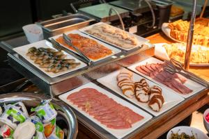 a buffet with different types of meats and other food at Wyndham Garden Burabay in Borovoye