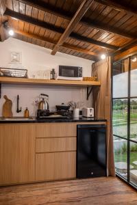 a kitchen with a stove and a microwave at Emy Kerobokan in Kerobokan +57 photos