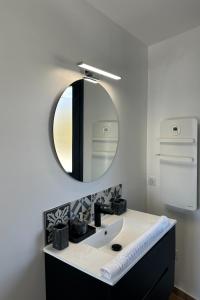 a bathroom with a sink and a mirror at La Love Room de St Nazaire les Eymes in Biviers