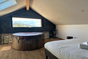 a bedroom with a large tub in the corner of a room at La Love Room de St Nazaire les Eymes in Biviers