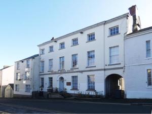 a large white building on the side of a street at Pass the Keys Luxury Apartment Ulverston 6 in Ulverston