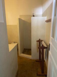 a bathroom with a toilet and a cross in a room at Fulvia House in Malindi