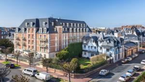 an aerial view of a city with houses and cars at La Closerie SPA & Résidence Hôtel in Deauville