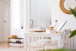 a white dining room with a white table and chairs at Casa San Miguel Terrace - Centro Zaragoza in Zaragoza +25 photos