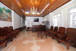 a waiting room with chairs and a podium and a chandelier at Villa KiengKham晶康民宿 in Luang Prabang