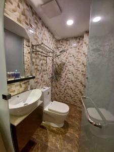 a bathroom with a toilet and a sink and a shower at MS Hotel Kuala Lumpur in Kuala Lumpur