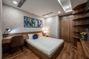a small room with a bed and a desk and a chair at An Corner - Terra Royal 2 Bedrooms Nice View in Ho Chi Minh City