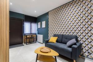 sala de estar con sofá azul y mesa en Hamac Suites - Suite du Parc 3 en Villeurbanne