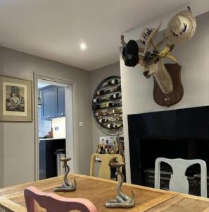 a dining room with a table and a fireplace at Remarkable 3-Bed House in the centre of Guildford in Guildford