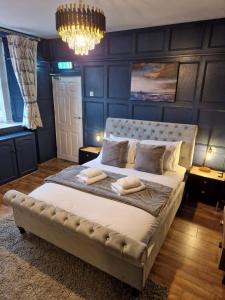 a bedroom with a large bed with two pillows on it at The Ship Inn in Holy Island