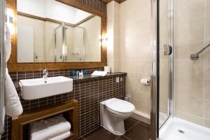 a bathroom with a toilet and a sink and a shower at Castle Green Hotel In Kendal, BW Premier Collection in Kendal