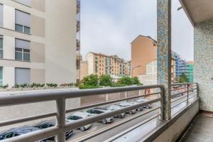 a balcony with cars parked in a parking lot at Milano Via Del Fusaro 4 PAX Wi-Fi in Milan