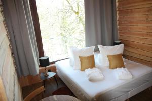 Łóżko lub łóżka w pokoju w obiekcie Villa Forêt et Spa