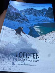 a magazine cover of a man skiing in the magic islands at New lodge at seaside, near Henningsvær Lofoten in Kleppstad