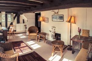 a living room with wicker chairs and a table at Toad Hall in Swilland