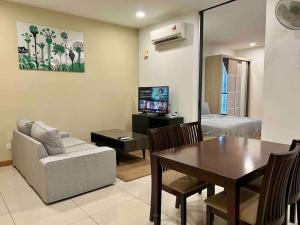 a living room with a couch and a dining room at KL Gateway Residency in Kuala Lumpur