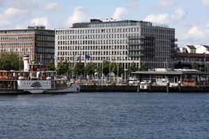 Ein Boot liegt an einem Dock in einer Stadt. in der Unterkunft ATLANTIC Hotel Kiel in Kiel
