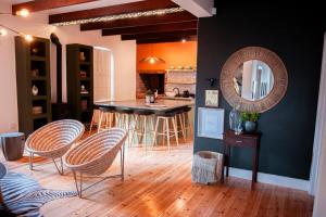 a kitchen with a table and chairs and a mirror at Hygge House in Robertson