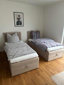 two beds sitting next to each other in a bedroom at Komfortables Penthouse 200 qm in Langen