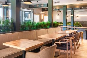 une rangée de tables et de chaises dans un restaurant dans l'établissement B&B HOTEL Valencia Aeropuerto, à Paterna