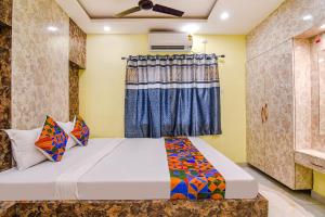 a bedroom with a bed and a window at FabHotel Divine Chariot in Kolkata