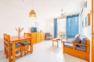 a living room with a table and a dining room at Can Vidal Ibiza in Ses Salines