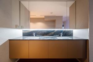 a bathroom with two sinks and a large mirror at Luxury House at Xanadu Residence in Ulaanbaatar