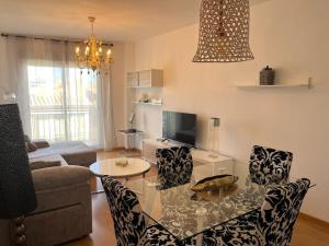 a living room with a glass table and chairs at Cardenas Home Azabache in Santa Fe