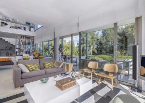 a living room with a couch and a table at Olivo - Sol de Mallorca in Sol de Mallorca