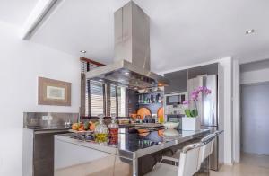 a kitchen with a stainless steel counter top in a room at Olivo - Sol de Mallorca in Sol de Mallorca