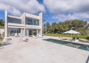 a villa with a swimming pool and a house at Olivo - Sol de Mallorca in Sol de Mallorca