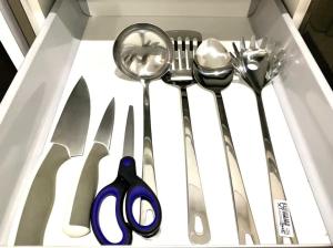 a drawer with some utensils in a box at KL Gateway Residency in Kuala Lumpur