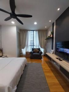 a bedroom with a bed and a tv and a couch at KL Gateway Residency in Kuala Lumpur