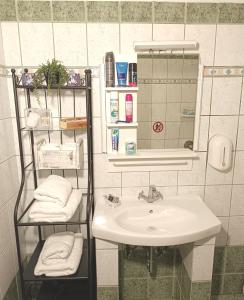 a bathroom with a sink and a mirror at Georgias house 7 min from Athens airport in Artemida