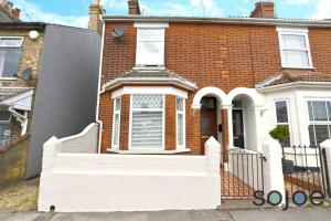 a brick house with a white staircase in front of it at Charming and spacious 3 bedroom house very close to the beach in Lowestoft